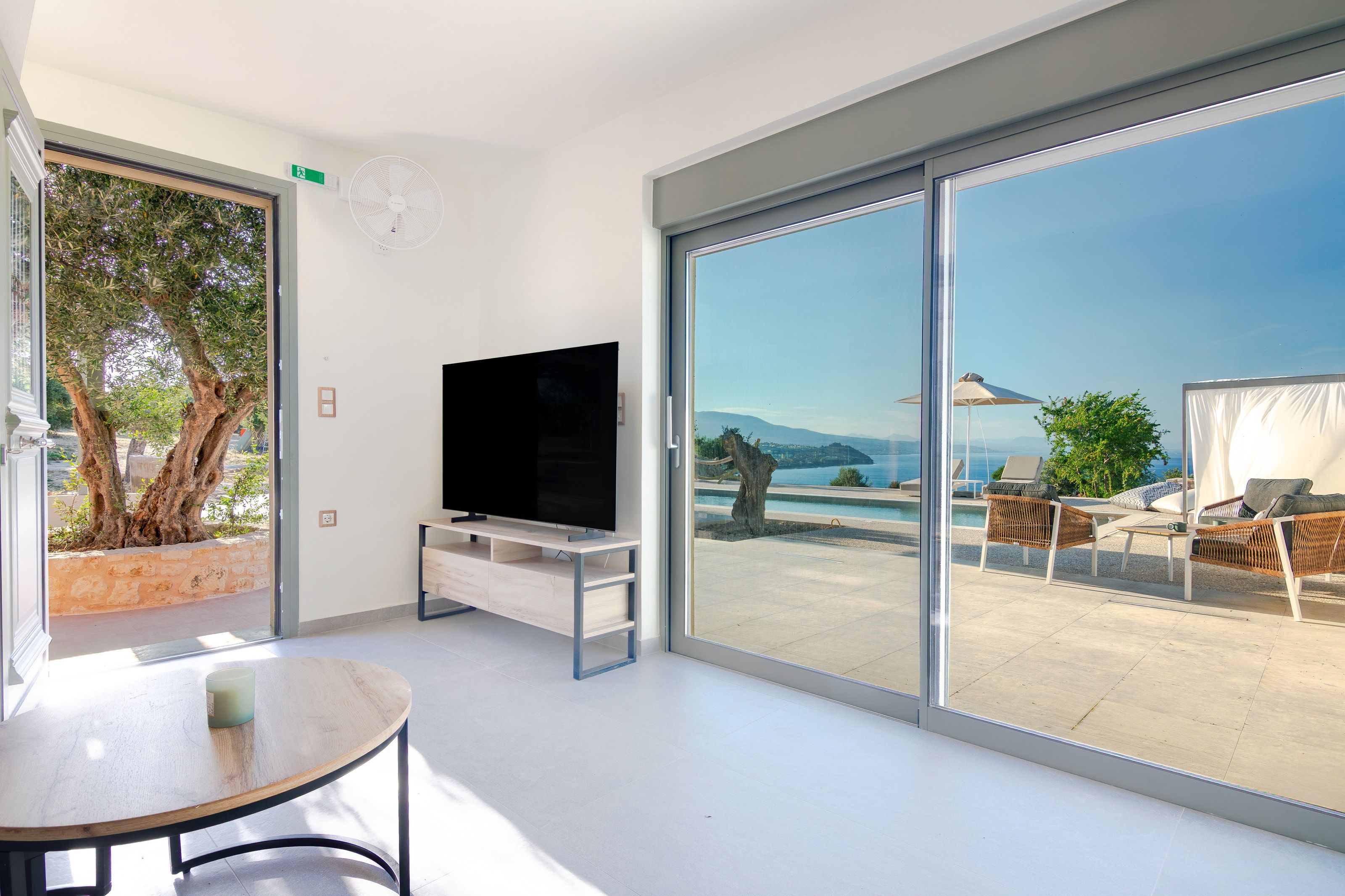 Ground-floor apartment living room opening onto the pool terrace